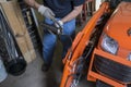 Mechanic Using A Grease Gun Royalty Free Stock Photo