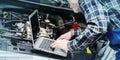 Mechanic using laptop for checking car engine, geometric pattern
