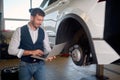 Mechanic Using Laptop While Examining Car Engine Royalty Free Stock Photo