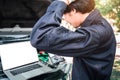 Mechanic Using Laptop While Examining Car Engine, pointing in blank screen Royalty Free Stock Photo