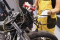 Mechanic using multimeter checks voltage level motorcycle battery motorcycle garage Royalty Free Stock Photo