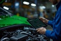Mechanic using tablet for car diagnostics Royalty Free Stock Photo