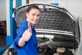 Mechanic using tablet to fix car Royalty Free Stock Photo