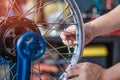 Mechanic using a wrench and socket Adjustment of a motorcycle ri