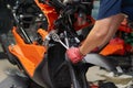 Mechanic using a wrench and socket on the engine of a motorcycle , selective focus Royalty Free Stock Photo