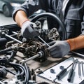 A mechanic wearing gloves is assembling a complex automotive steering mechanism with precision tools on a workbench