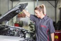 Mechanic woman working on car in his shop Royalty Free Stock Photo