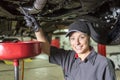 Mechanic woman working on car in his shop Royalty Free Stock Photo