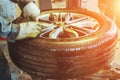 Mechanic worker makes computer wheel balancing in auto repair service