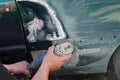 Mechanic worker repairman fixing by sanding polishing car body and preparing for painting at station service Royalty Free Stock Photo