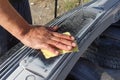 Mechanic worker repairman sanding polishing car bumper and preparing bumper for painting during repair Royalty Free Stock Photo