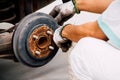 A mechanic worker replacing brake fluid.