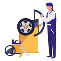 Mechanic worker with tire changer machine Royalty Free Stock Photo