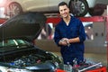 Car mechanic in auto repair shop Royalty Free Stock Photo