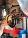 Mechanic working on car brakes Royalty Free Stock Photo