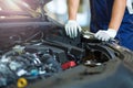 Mechanic working on car engine in auto repair shop Royalty Free Stock Photo