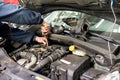 Mechanic working on a car engine doing repairs Royalty Free Stock Photo