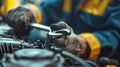 a mechanic is working on a car engine with a wrench Royalty Free Stock Photo