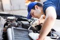 Mechanic working on a car engine Royalty Free Stock Photo