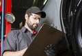 Mechanic working on car in his shop Royalty Free Stock Photo