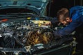 Mechanic working in car motor. Royalty Free Stock Photo