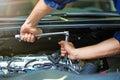 Mechanic working on engine in auto repair shop