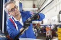 Mechanic working on windshield wipers of car Royalty Free Stock Photo