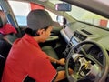 The mechanic works to fix the damaged car