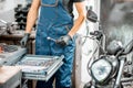 Mechanic with wrenches in the workshop