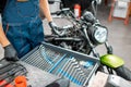 Mechanic with wrenches in the workshop