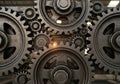 Of variously-sized interlocking gears, made of metal with a rugged Royalty Free Stock Photo