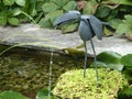 Mechanical bird in a pond in Castillon garden in Normandy in France.