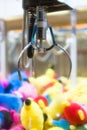 Mechanical claw game machine. Royalty Free Stock Photo