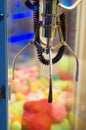 Mechanical claw game machine. Royalty Free Stock Photo