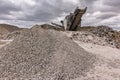 Mechanical conveyor belt to pulverize rock and stone and generate grave Royalty Free Stock Photo