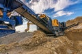 Mechanical conveyor belt to pulverize rock and stone and generate gravel Royalty Free Stock Photo