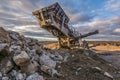 Mechanical conveyor belt to pulverize rock and stone and generate gravel