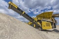 Mechanical conveyor belt to pulverize rock and stone and generate gravel Royalty Free Stock Photo