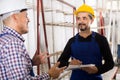 Mechanical engineer inspecting the work of labour at factory