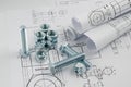 Mechanical Engineering Technology. Nuts and bolts on paper drawings Royalty Free Stock Photo