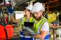 Mechanical engineers repairing engine machine at factory Royalty Free Stock Photo