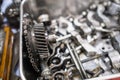 The mechanical guy removes the gear part from the diesel engine box and puts on the plate with other nuts and part. Diesel engine Royalty Free Stock Photo