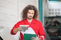 Mechanical man with a checklist inspecting car parts stock in garage warehouse, Young mechanic working in auto repair shop Royalty Free Stock Photo