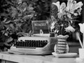 Mechanical military Bisel semi-portable typewriter. Pot of pink flowers. Restaurant advertising vintage accessory. Eye catcher.