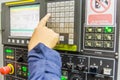 Mechanical technician working with Control Panel of CNC machine center at tool workshop Royalty Free Stock Photo