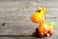 Mechanical wind up plastic giraffe toy. Pretty clockwork children toy on old wooden background. Fun children background Royalty Free Stock Photo