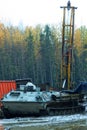 Mechanically driven drill in forest