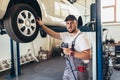 Mechanician changing car wheel in auto repair service