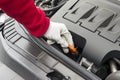 Mechanician performing maintenance on a car engine Royalty Free Stock Photo