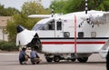 Mechanics analyzing and repairing a Skyvan plane before the flight.